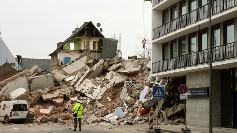 Ein Polizist steht vor dem eingestürzten Kölner Stadtarchiv
