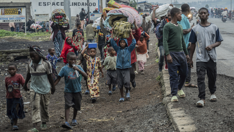 People displaced by the fighting with M23 rebels make their way to the center of Goma, Democratic Republic of the Congo, Sunday, Jan. 26, 2025. (AP Photo/Moses Sawasawa)