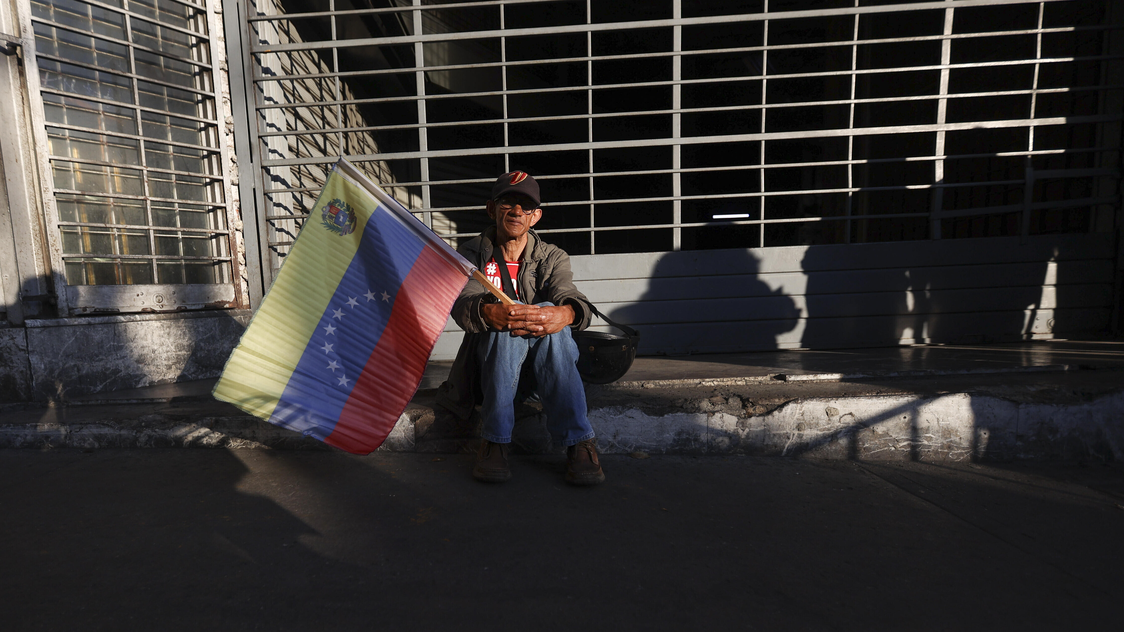 Supporter of Venezuelan President Nicolas Maduro with a flag during a demonstration in Caracas, Venezuela, on January 04, 2026.