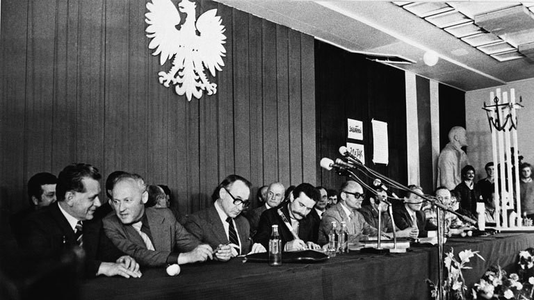 Representing the Polish government Mieczyslaw Jagielski (3-L), Solidarity Trade Union chairman Lech Walesa (4-L) and Tadeusz Fiszbach (5-L) sign the so called 'Gdansk Agreement' final agreement between the government commitee and the interfactory strikers' committee at the Lenin Shipyard in Gdansk, Poland, 31 August 1980.