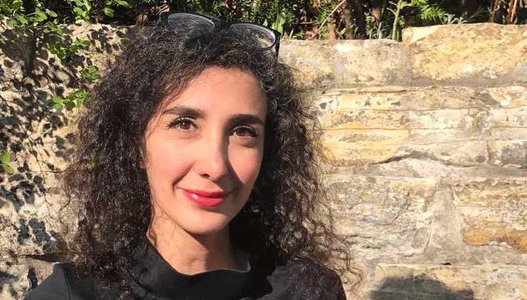 Die Anwältin Asha Hedayati vor einer Mauer