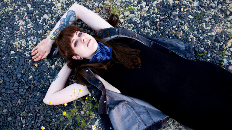 Eine Junge Frau liegt auf dem Boden und starrt in die Luft