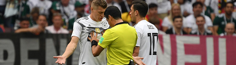 17.06.2018, Russland, Moskau: Fußball: WM, Vorrunde, Gruppe F, 1. Spieltag: Deutschland - Mexiko im Luschnikistadion. Toni Kroos (l) und Mesut Özil (r) aus Deutschland diskutieren mit Schiedsrichter Alireza Faghani. Foto: Ina Fassbender/dpa