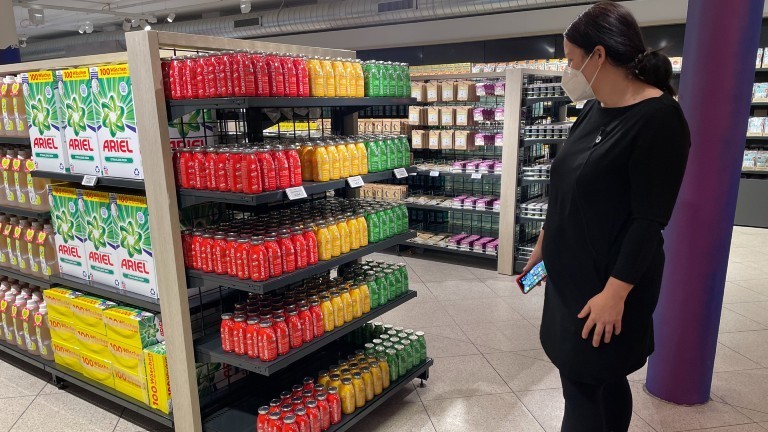 Antje Lienert steht vor einem Regal im Test-Supermarkt