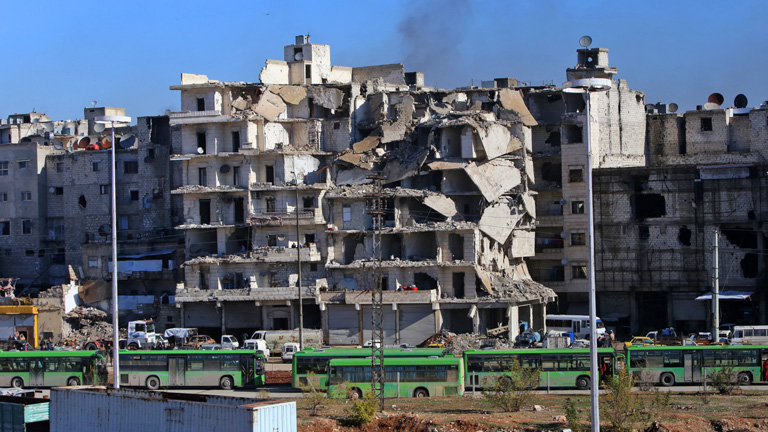 Busschlange im zerstörten Aleppo