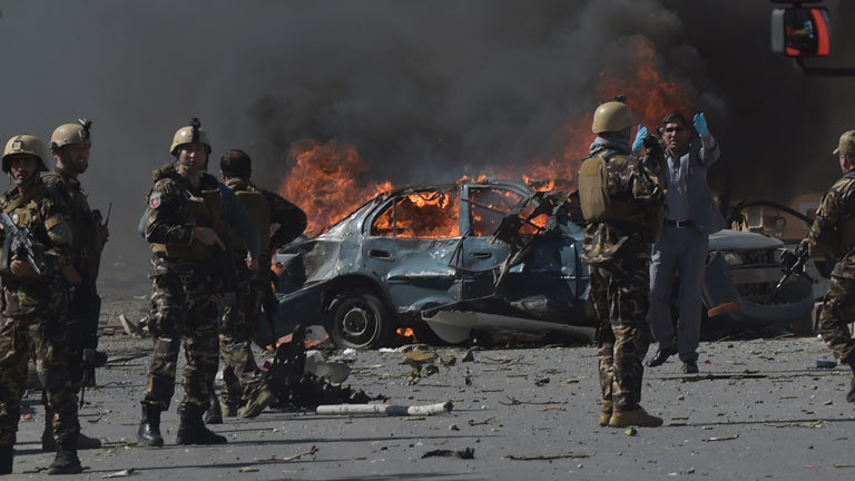 Afghan security forces personnel are seen at the site of a car bomb attack in Kabul on May 31, 2017. At least 40 people were killed or wounded on May 31 as a massive blast ripped through Kabul's diplomatic quarter, shattering the morning rush hour and bringing carnage to the streets of the Afghan capital.