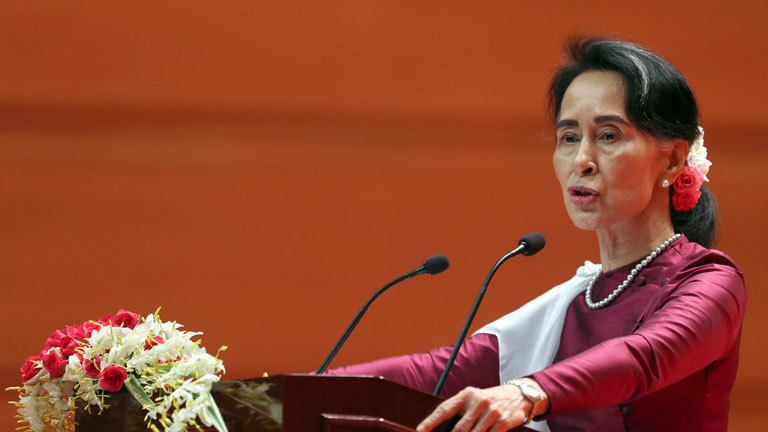 Myanmar's State Counsellor Aung San Suu Kyi delivers a televised speech to the nation at the Myanmar International Convention Center in Naypyitaw, Myanmar, Tuesday, Sept. 19, 2017. Suu Kyi said Tuesday that most Rohingya villages weren't hit by violence. She invited foreign diplomats gathered in the capital for her speech to visit villages that were unaffected.