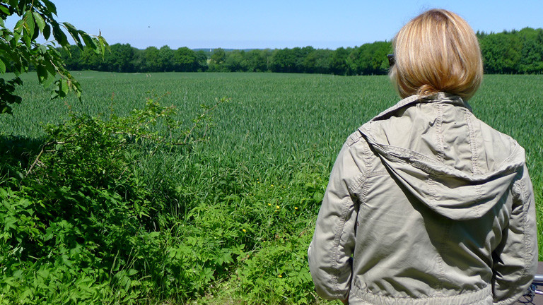 Anne Bente Isenberg blickt auf ein Feld.