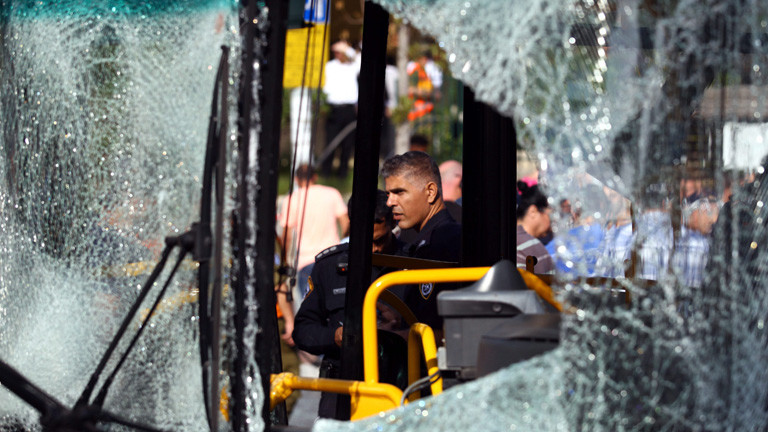 An Israeli policeman inspects the scene after a terrorist attack on a bus in central Tel Aviv, Israel, 21 November 2012.
