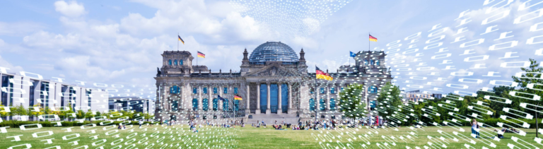 Der Bundestag im Frühling, auf das Bild wurde eine Flut von Nullen und Vieren gesetzt, um einen Hackerangriff zu symbolisieren