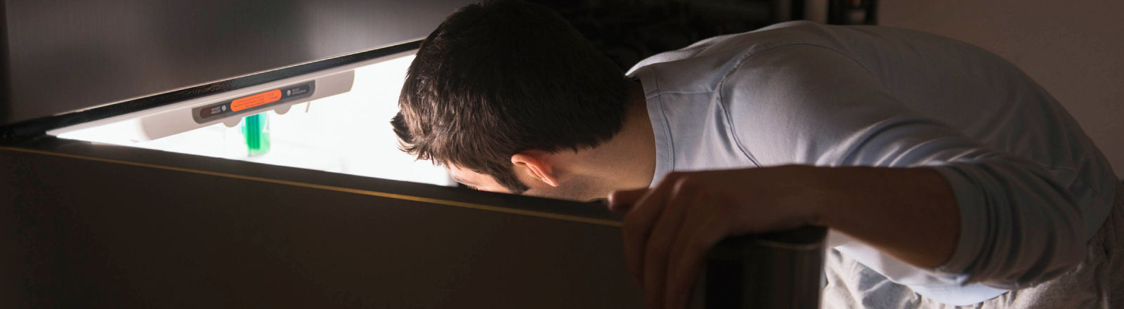 Es ist Nacht: ein Mann, ein Kühlschrank.