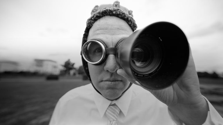 Ein Mann blickt durch ein Fernrohr.