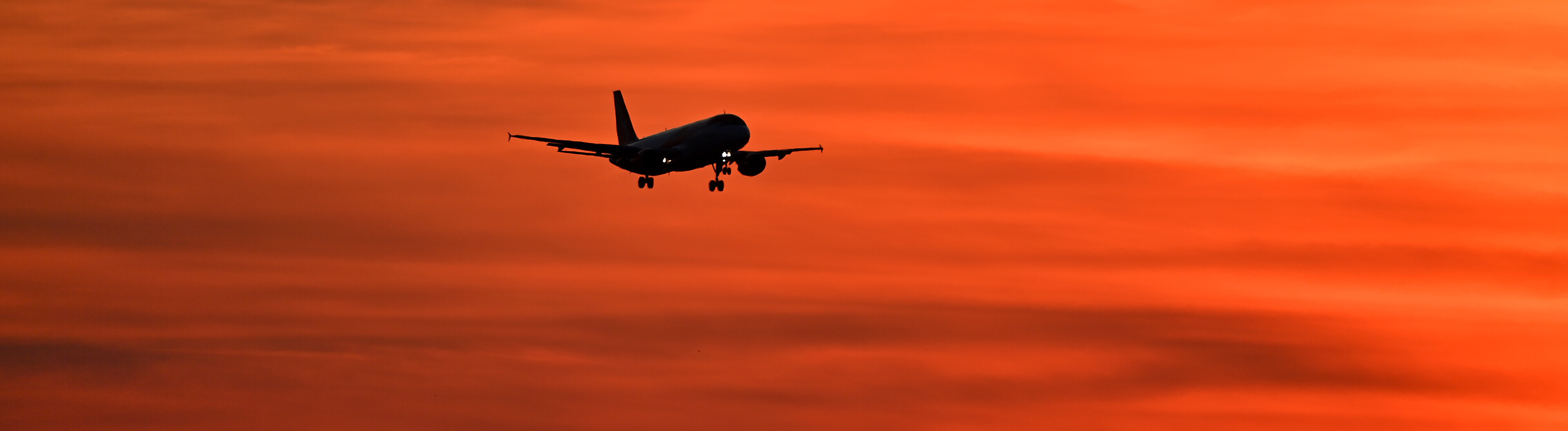 Flugzeuge am Airport Muenchen fliegt im Sonnenuntergang