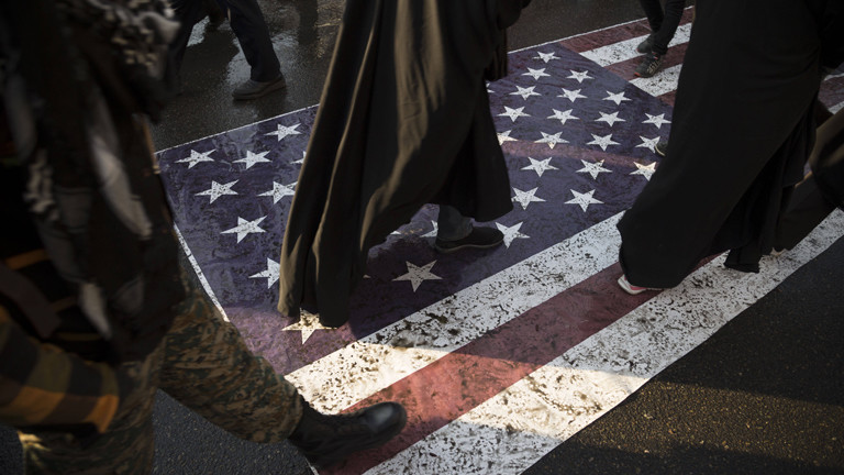 Füße gehen über eine amerikanische Flagge auf dem Boden.