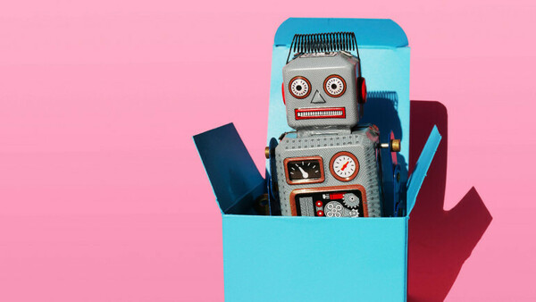 Studio shot of vintage robot toy in turquoise gift