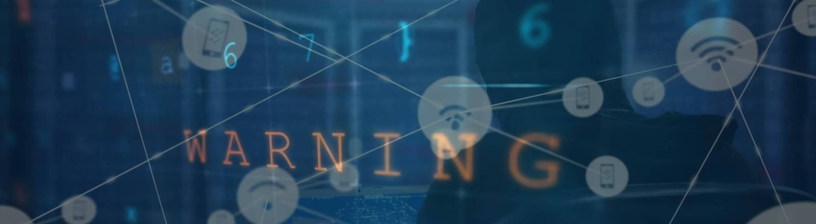 Symbolbild für Cyberangriff: Datenverarbeitung auf einem Bildschirm mit Aufschrift "Warnung" und Hacker. im Hintergrund