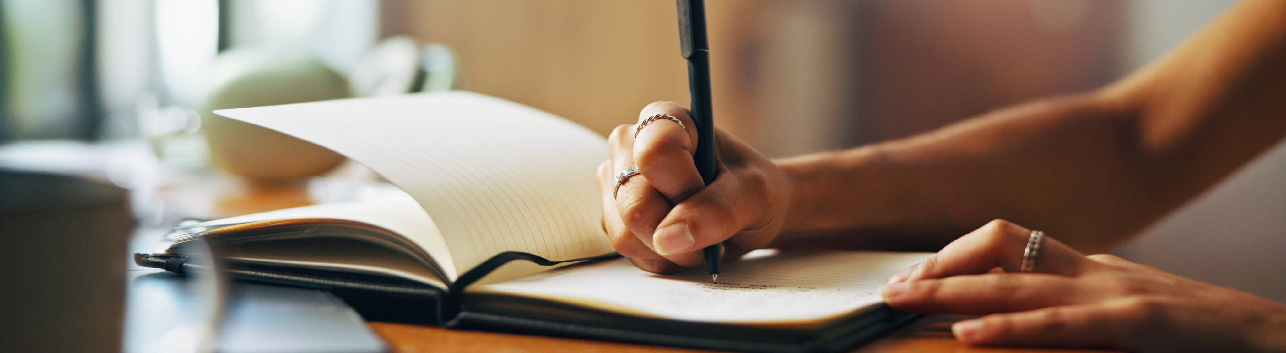 Jemand schreibt eine Liste in ein Notizbuch