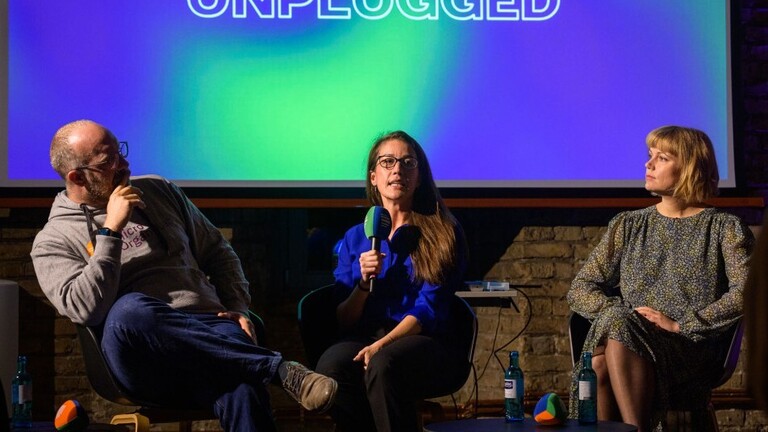 Drei Diskussionsteilnehmer auf der Bühne