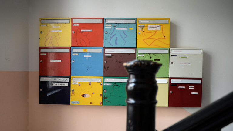 Bunte Briefkästen in einem Mietshaus