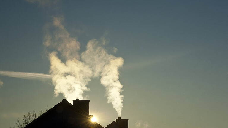 Rauch steigt aus den Schornsteinen zweier Wohnhäuser