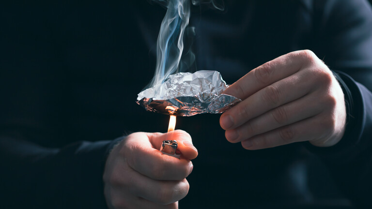Drogenabhängiger Mann bereitet Heroin für den Konsum vor.