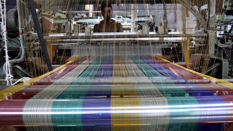 Ein Arbeiter an einem Webstuhl in einer Textilfabrik in Bangladesch