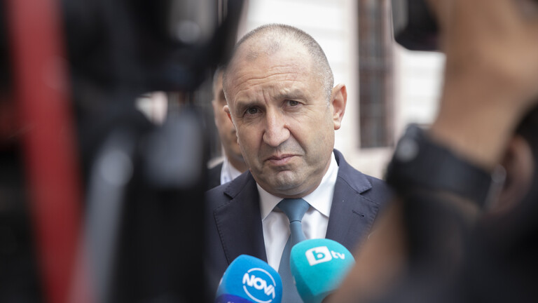 Rumen Radew steht vor Mikrofonen und blickt direkt in die Kamera.