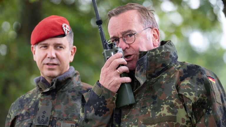 Bundesverteidigungsminister Boris Pistorius, rechts, spricht in ein Funkgeraet, links: Oberst Olaf Tuneke, Leiter der Artillerieschule, Bundesverteidigungsminister Boris Pistorius besucht die Artillerieschule in Idar-Oberstein am 16.09.2024
