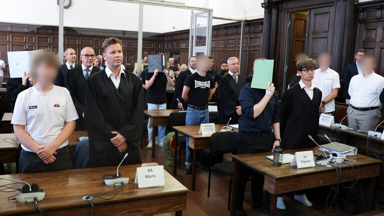 Sieben Angeklagte stehen mit ihren Verteidigern im Sitzungssaal im Hamburger Strafjustizgebäude zu Beginn des Prozesses gegen die rechtsextreme Terrorgruppe „Letzte Verteidigungswelle“.