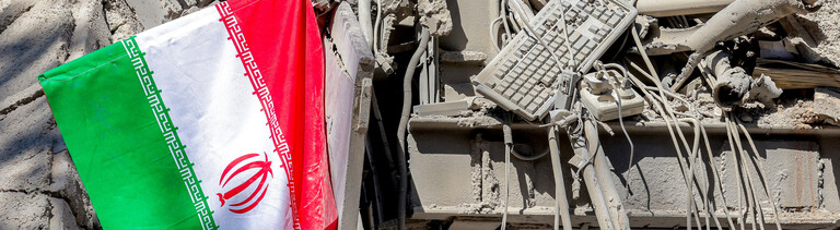 Iranische Flagge liegt neben den Trümmern eines eingestürzten Gebäudes nach den Anschlägen an der Sharif University of Technology in Teheran (Iran, 7.04.2026)