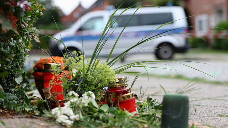 Blumen und Kerzen stehen auf der Straße zum Gedenken an sechs Menschen, die bei einer Schießerei in Stade in Niedersachsen ums Leben kamen (30.06.2026)