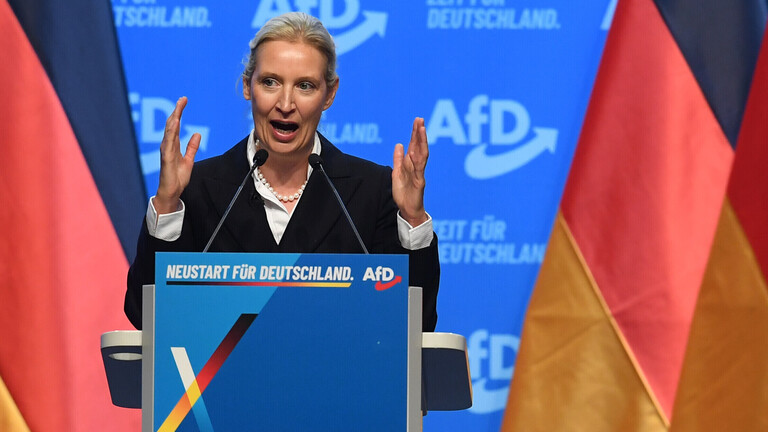 Foto der AfD-Parteivorsitzenden Alice Weidel bei einer Rede während des 17. Bundesparteitag der Alternative für Deutschland am 04.07.2026 in der Messe Erfurt in Erfurt am Rednerpult umrahmt von Deutschlandflaggen