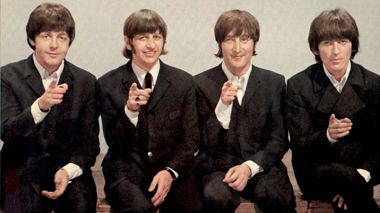 Die Beatles auf einem Foto aus dem Jahr 1966 - Paul McCartney, Ringo Starr, George Harrison und John Lennon zeigen mit dem Finger in die Kamera.