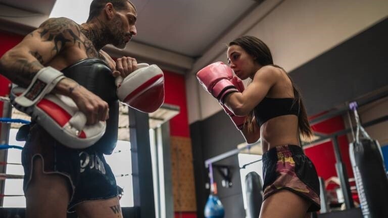Eine Frau und ein Mann beim Kampfsporttraining