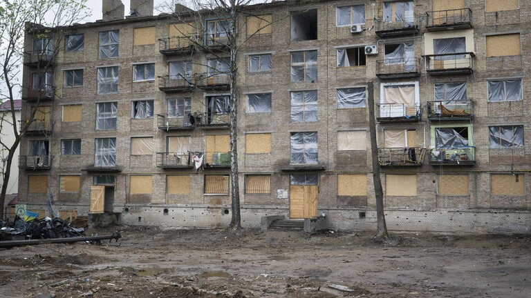 In der ukrainischen Hauptstadt Kiew steht ein Wohnhaus, bei dem die Fenster durch einen Militärangriff zerstört wurden. Anstelle der Fenster ist dort Plastikfolie angebracht.